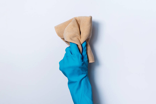 Hand in glove holding microfiber cleaning cloth on white background. Copy space. Cleaning service concept. Spring general or regular clean up. Commercial cleaning company concept. - Fotografie, Obrázek