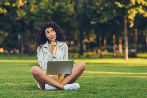 Full size photo of optimistic brunette hairdo lady sit think write laptop wear yellow dress jacket outside in park - Fotoğraf, Görsel