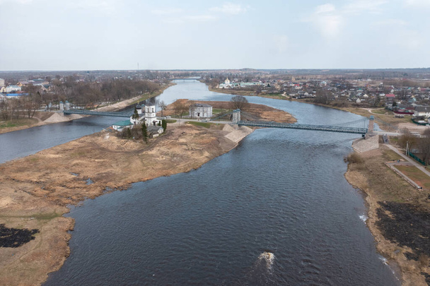 Drone view of a unique chain bridge and an island in the Velikaya river in the city of Ostrov, Pskov region. Tourist center of regional Russia. - Photo, Image