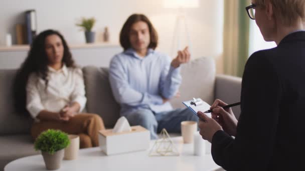 Érzelmi házaspár, akik személyes problémákról és állításokról beszélnek a pszichoterapeutával folytatott családi konzultáció során. - Felvétel, videó