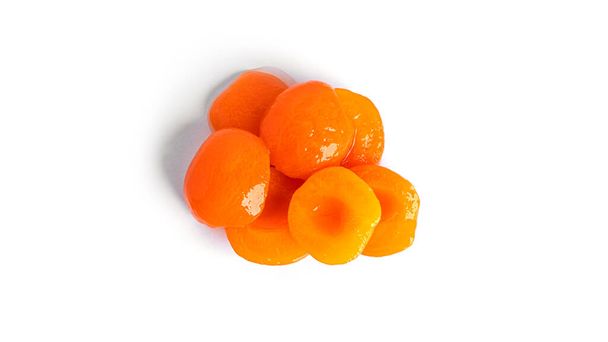Canned apricots isolated. Sweet apricots in syrup isolated on white background. - Fotoğraf, Görsel