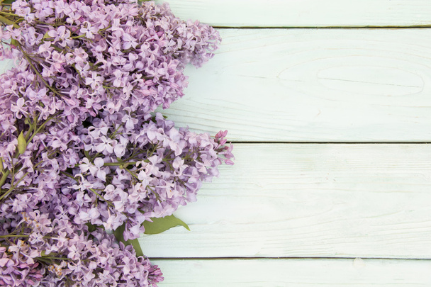 sprig of lilac lies on a wooden surface - Фото, зображення