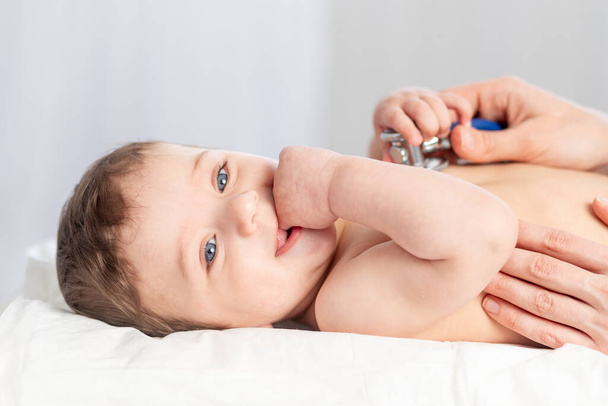 pediatria, lääkäri tutkii poikavauvan ja käyttää stetoskooppia kuuntelemaan vauvan sykettä tai hengitystä, lääketieteen ja terveyden käsitettä. - Valokuva, kuva