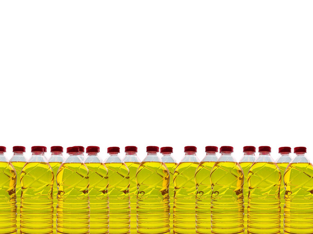 Bottiglie di plastica con olio di soia commestibile su sfondo commerciale e a tema. L'olio di soia è un tipo di olio vegetale estratto dai semi di soia ed è ricco di grassi polinsaturi, omega 3 e 6 e vitamina E. - Foto, immagini