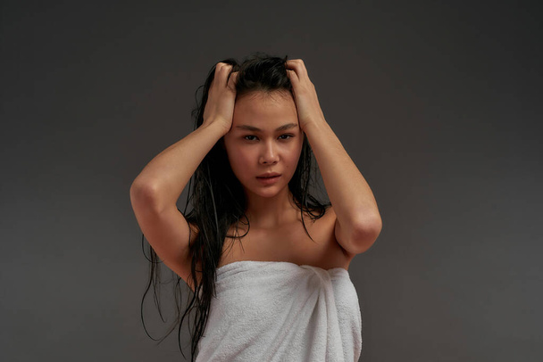 Young beautiful asian half naked woman tousled her hair in bath towel  - Photo, image