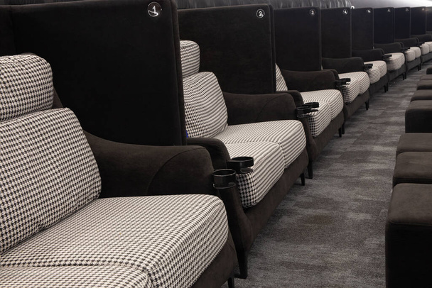 Soft fabric light double seats in row at movie theater - Фото, изображение