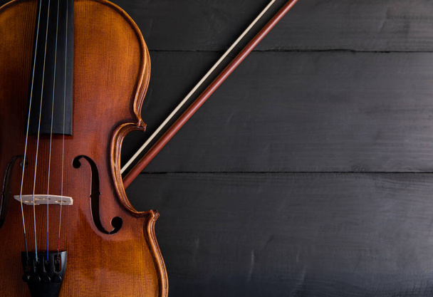 beautiful violin on black wooden backgroun - 写真・画像