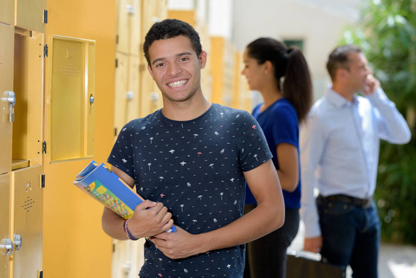student keeping his book in the locker in university - Fotó, kép