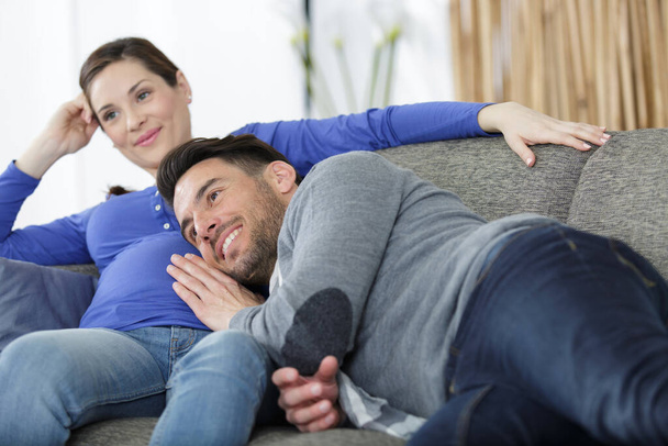happy man touching belly of smiling pregnant woman - Foto, Bild