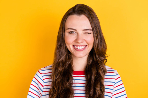 Photo of charming sweet young woman wear striped outfit smiling winking isolated yellow color background - Φωτογραφία, εικόνα