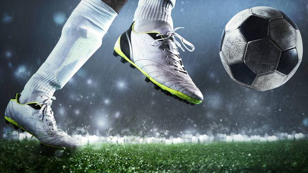 Close up of a soccer scene with player kicking the ball with power - Photo, Image