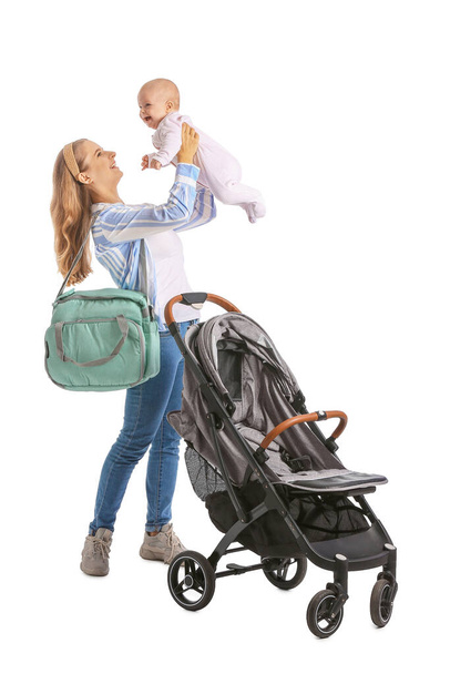 Vrouw met haar schattige baby en kinderwagen op witte achtergrond - Foto, afbeelding