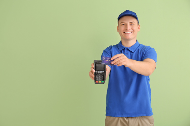 Courier with payment terminal on color background - Photo, Image