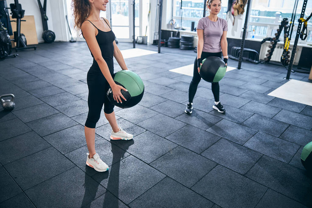 Two young female athletes performing an exercise - Photo, Image