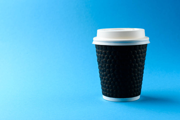 Coffee paper cup on blue background. - Foto, Imagem