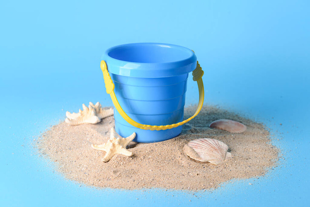 seau jouet pour les enfants avec du sable sur fond de couleur - Photo, image