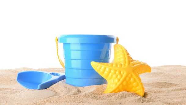 Set of beach toys for children on sand against white background - Foto, afbeelding