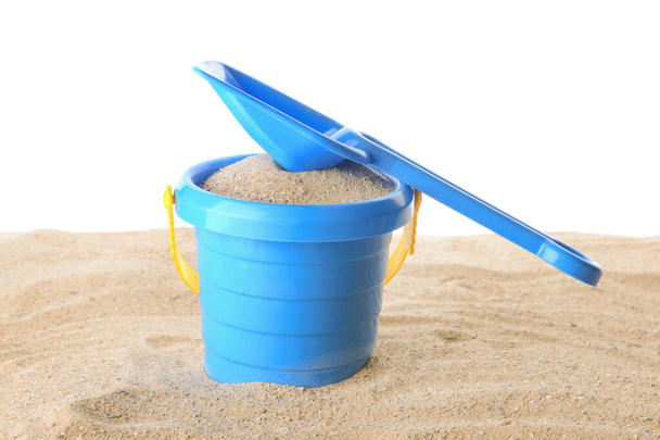 Toy bucket and shovel for children with sand on white background - Photo, Image