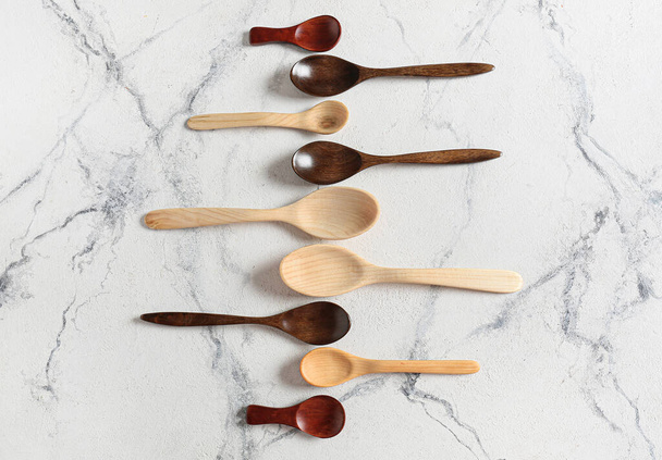 Different wooden spoons on color background - Photo, Image