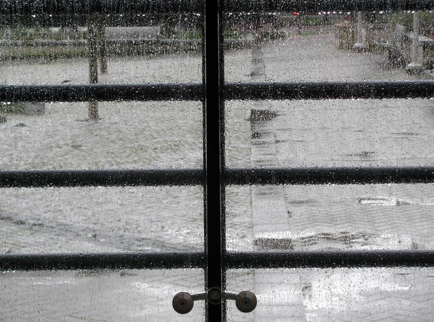 Rain drops on the glass balcony panels. Yaletown, Vancouver, BC, Canada - Photo, Image