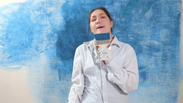 Σχεδιάστρια κυρία με πουκάμισο χορεύει τραγουδώντας σε πινέλο ως μικρόφωνο - Πλάνα, βίντεο