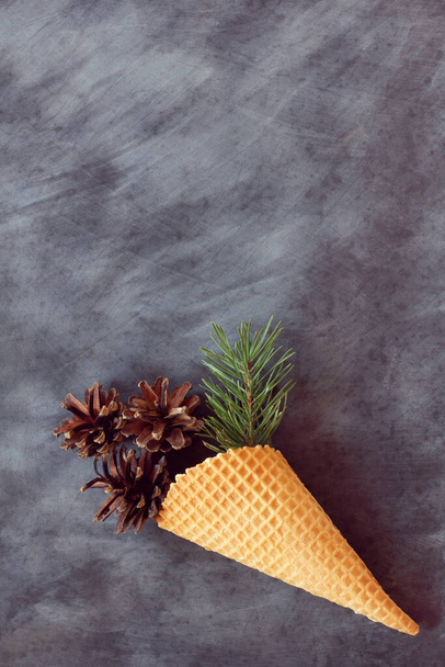 waffle cone with fir branches and cones on the background of the school board / background for the winter holidays - Zdjęcie, obraz