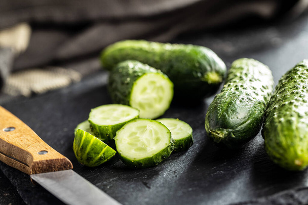 Sliced fresh green cucumbers on cutting board. - Photo, image