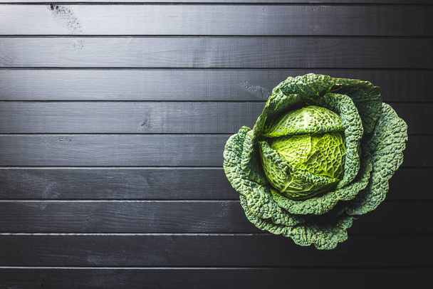 Green savoy cabbage on wooden table. Top view. - Foto, Imagem