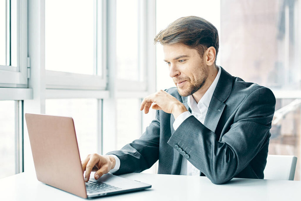 business man sitting at his desk in front of laptop office - Fotó, kép