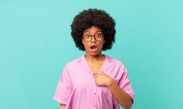 afro black woman looking shocked and surprised with mouth wide open, pointing to self - Фото, изображение