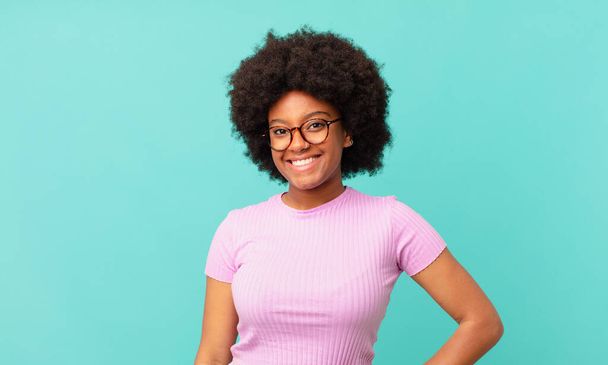 afro black woman smiling happily with a hand on hip and confident, positive, proud and friendly attitude - Фото, изображение