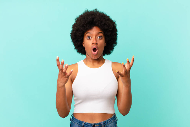 afro black woman open-mouthed and amazed, shocked and astonished with an unbelievable surprise - Foto, Imagem