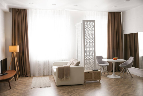 Modern living room with parquet floor and stylish furniture - Fotó, kép