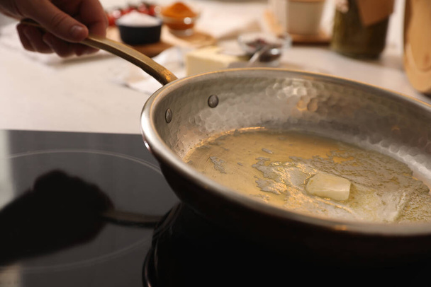 Frying pan with melted butter on stove, closeup - Photo, Image