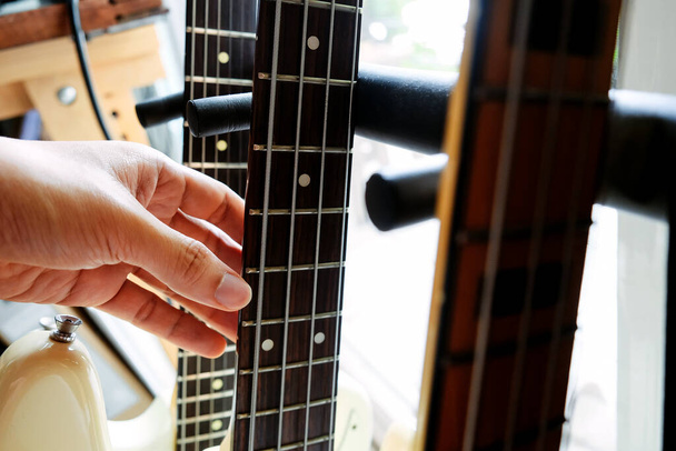 close up Image of Hand picking up guitar  - Photo, Image