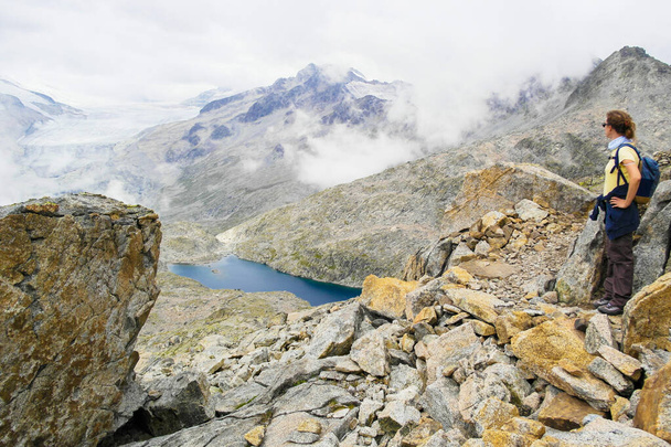 View on dark lake on Passo del Tonale, Lombardy - Italy - Photo, Image