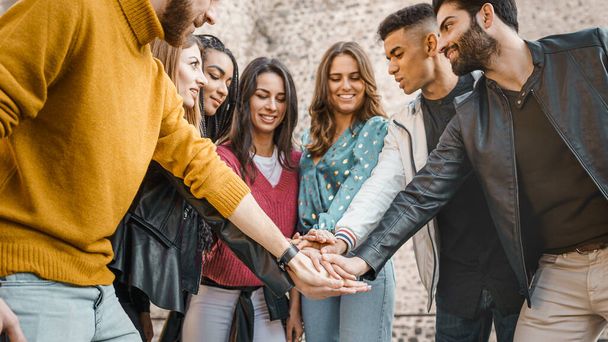 millennial generation multiracial young people with hands in stack. Trust, unity, togetherness and friendship lifestyle concept - Фото, изображение