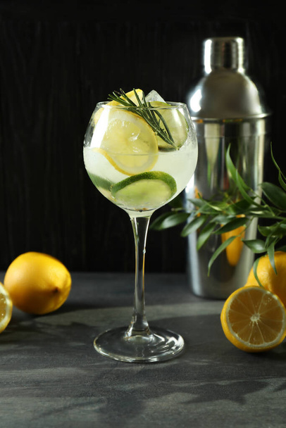 Glass of cocktail with citrus against wooden background - Photo, Image