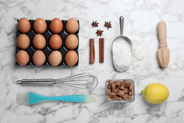 Cooking utensils and ingredients on white marble table, flat lay - Foto, immagini