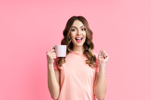 Young happy woman enjoying cup of aroma coffee - Φωτογραφία, εικόνα