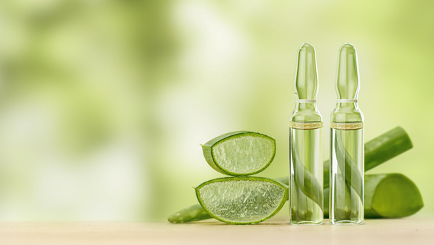 aloe vera extract in ampoules on a wooden table. natural cosmetic - Photo, Image