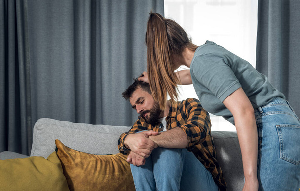 Newly married young couple where a woman attacks and mentally abuses her young husband due to sick jealousy and possessiveness and he suffers from domestic violence trying to defend himself  - Фото, изображение