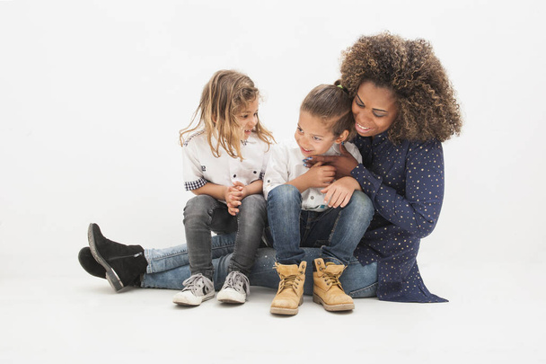 Happy Brazilian mother with two children, on the white background. Multiethnic children. Happy mother's day concept - Foto, Bild