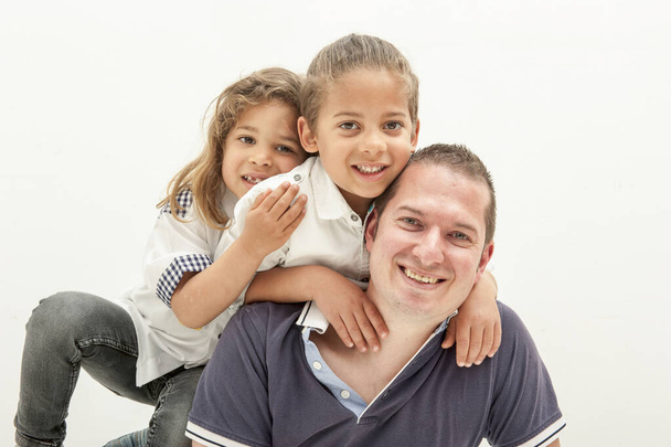 happy young caucasian father having fun with little multiracial children Happy dad plays engaged in fun activities with little multi-ethnic children. Father's day concept - Photo, Image