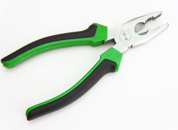 Flat-nose pliers with green handles and black strips on a white background - 写真・画像