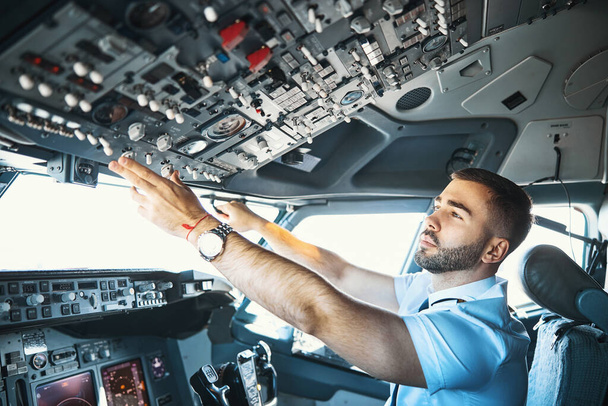 Making final preparations in the flight deck of passenger aircraft - 写真・画像