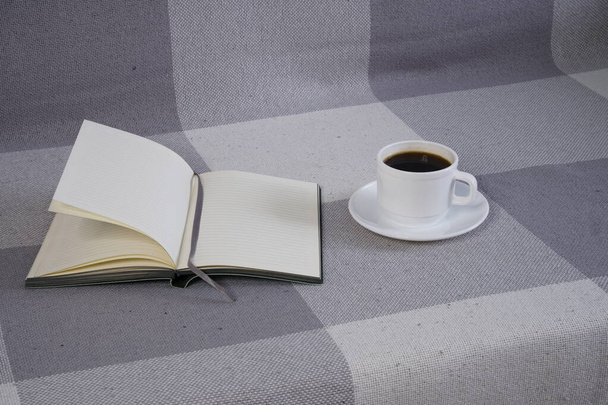 A cup of coffee and a notebook on the couch. Interior. Home Office. - Foto, Bild