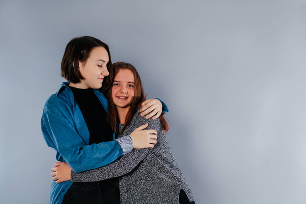 Two teenage sisters are hugging each other - Foto, Imagem