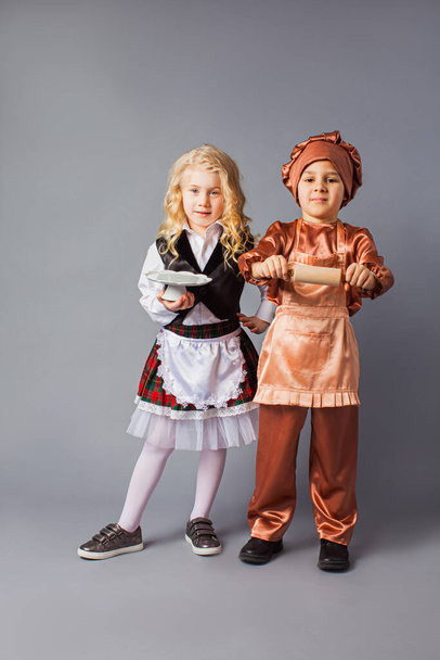 Kids pose in the costumes of a waiter and a cook - Zdjęcie, obraz