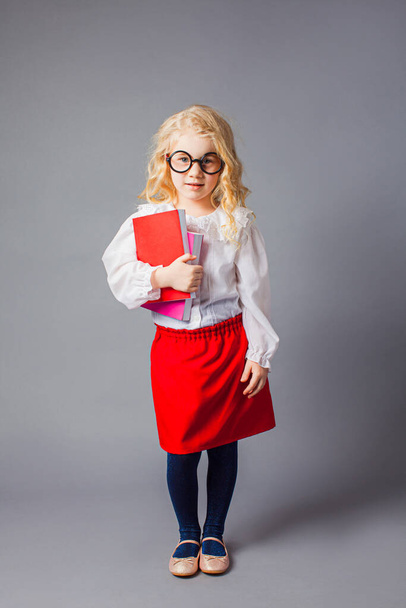 The pretty little girl with glasses dressed in teacher uniform - Photo, image